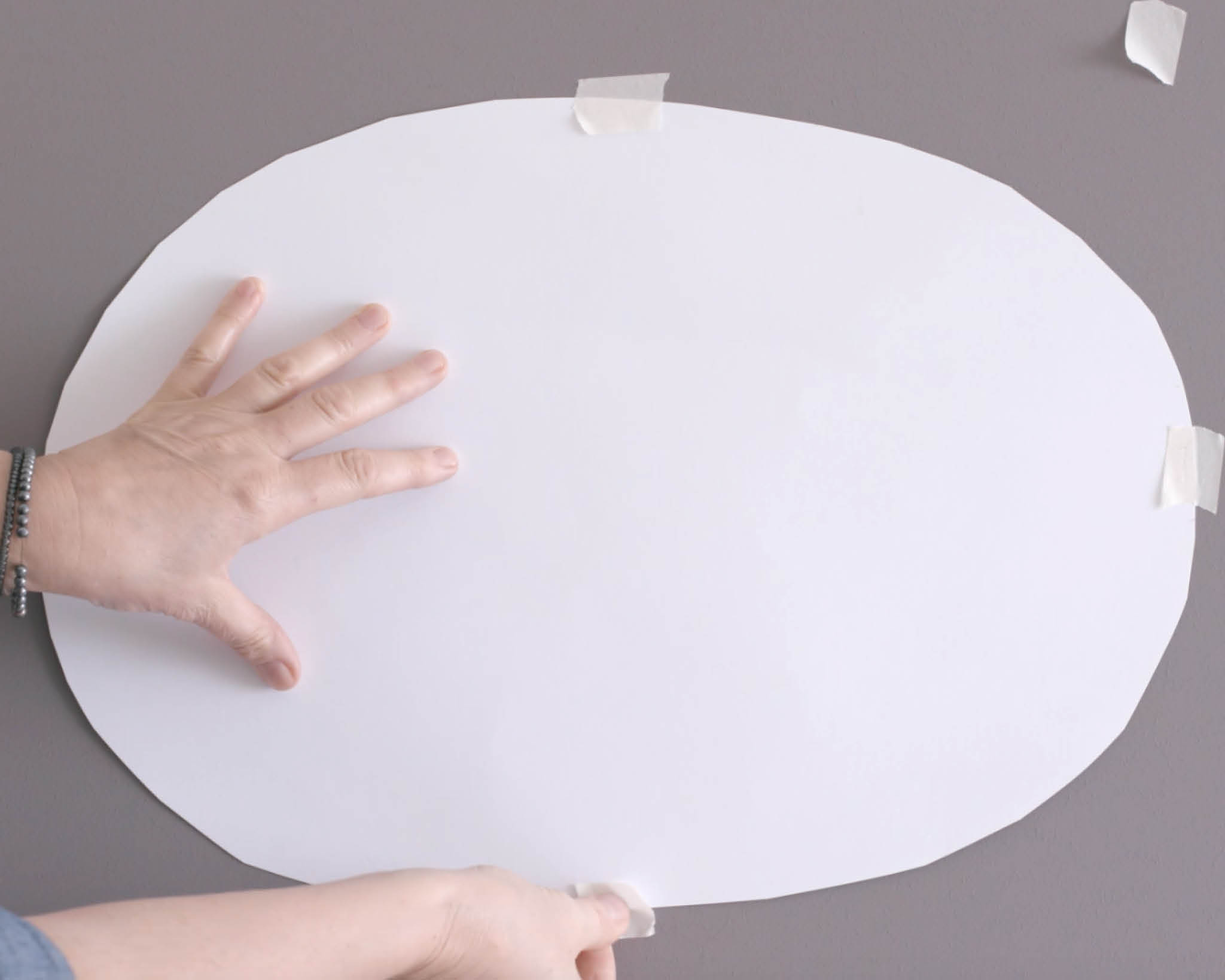 Oval taped to wall Tape your oval to the area you’d like to paint